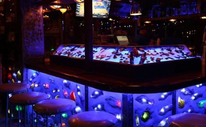 close up of seacrets raw bar at night lit up