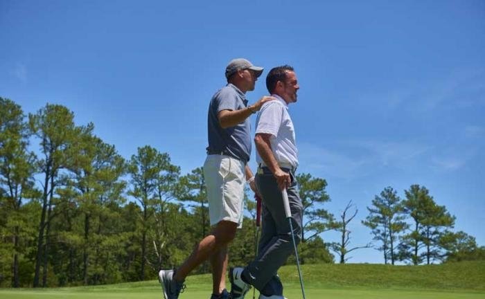 two golfers standing together on golf course